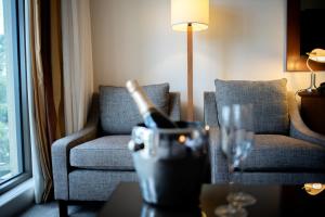 a living room with a couch and a wine glass at Yarra Valley Lodge in Wonga Park