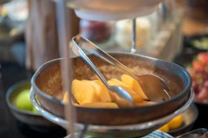a metal bowl of food with two spoons in it at Yarra Valley Lodge in Wonga Park