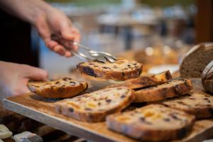 a person is preparing bread on a cutting board at Yarra Valley Lodge in Wonga Park