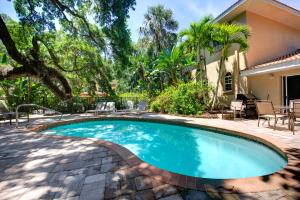 a swimming pool in the backyard of a house at Beautiful property on Siesta Key in Siesta Key
