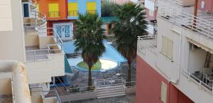 a view of a swimming pool between two buildings at Sunset apartments in Orikum