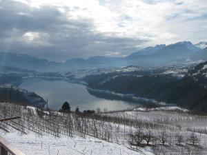 a view of a river in a valley with snow at Agritur Vista Lago in Revò