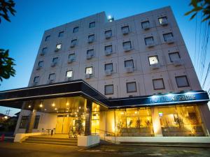 a large building with a store in front of it at Hotel Areaone Tokai in Funaishikawa