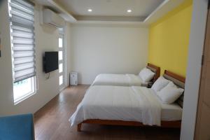 En eller flere senge i et værelse på 梅花湖 轉角民宿