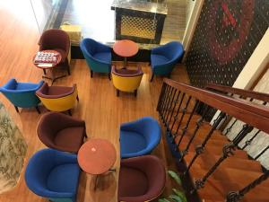 a group of chairs and tables in a room at Bamboo Green Riverside Hotel in Danang
