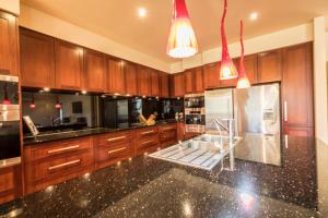 a kitchen with wooden cabinets and a black counter top at 141 Providence Drive, Bowhill in Bow Hill