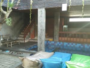 a living room with a couch in front of a house at Made House Homestay and Dormitory in Sanur