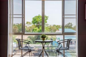 a table and two chairs in front of a window at Super nice townhouse in city center, 10 minutes walk to beach, night market ... in Hua Hin