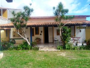 a house with palm trees in front of it at Casa em Cabo Frio in Cabo Frio