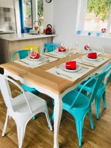 a wooden table with blue chairs around it at Casa Boutique in Chillán