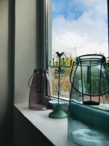 a window sill with two vases and a candle holder at Casa Boutique in Chillán