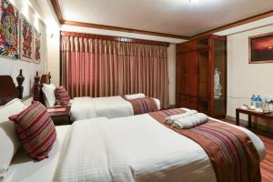 Ένα ή περισσότερα κρεβάτια σε δωμάτιο στο Nepal Pavilion Inn