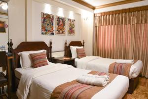 Ένα ή περισσότερα κρεβάτια σε δωμάτιο στο Nepal Pavilion Inn