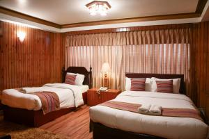 Ένα ή περισσότερα κρεβάτια σε δωμάτιο στο Nepal Pavilion Inn