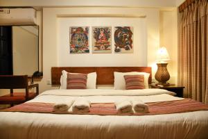Ένα ή περισσότερα κρεβάτια σε δωμάτιο στο Nepal Pavilion Inn