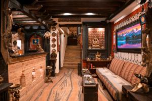 a living room with a couch and a television at Nepal Pavilion Inn in Kathmandu