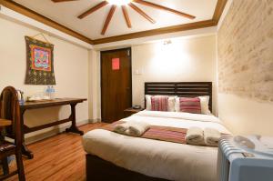 Ένα ή περισσότερα κρεβάτια σε δωμάτιο στο Nepal Pavilion Inn