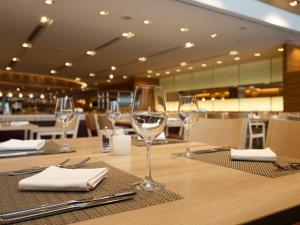 a table with wine glasses sitting on top of it at Haneda Excel Hotel Tokyu Haneda Airport Terminal 2 in Tokyo