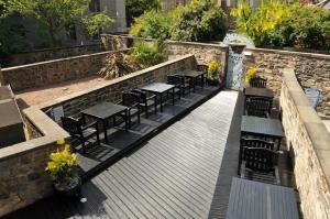 a row of tables and chairs on a wooden deck at The Hostel in Edinburgh