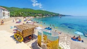 a beach with a bunch of people in the water at Holiday Home Prizba in Prizba +10 photos