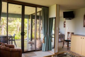 a living room with sliding glass doors to a patio at Titore Lodge in Russell