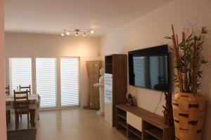 a living room with a television and a dining room at Casa Caliche in La Lajita