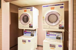 three washing machines on display in a room at Hotel Wing International Kobe - Shinnagata Ekimae in Kobe +160 photos