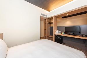 Giường trong phòng chung tại Traveller Inn Tiehua Cultural and Creative Hotel II