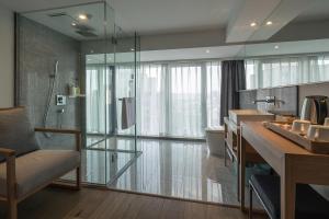 a bathroom with a shower and a sink and a toilet at Bai Yun Qin She Boutique in Chongqing