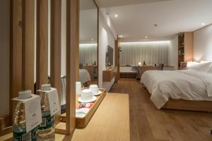 a hotel room with a bed and a bathroom at Bai Yun Qin She Boutique in Chongqing