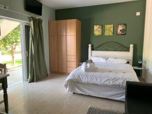 A bed or beds in a room at Anastasios Olive Garden Apartments