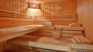 a wooden sauna with two beds and a bucket at Teghenis Resort in Tsaghkadzor