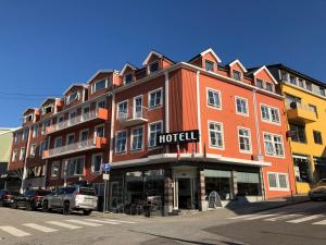 a large red building with a hotel on a street at Comfort Hotel Fosna in Kristiansund