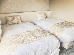 Postel nebo postele na pokoji v ubytování Framboise KYOTO Hotel de charme