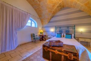 Llit o llits en una habitació de Masseria Sorani