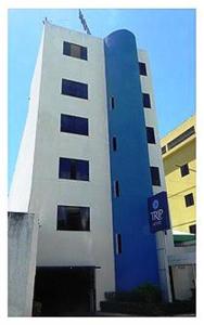 a blue and white building with a sign on it at Trip Hotel Lauro de Freitas in Lauro de Freitas