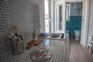 a kitchen with a stove in the middle of a bathroom at Belmar in Gaeta +26 photos