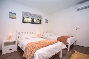 Posteľ alebo postele v izbe v ubytovaní Villa Nano, 4 bedrooms, jacuzzi, heated pool, sea views, pebble beach 850m