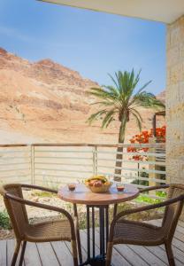 
a table with chairs and a table cloth at Ein Gedi Kibbutz Hotel in Ein Gedi
