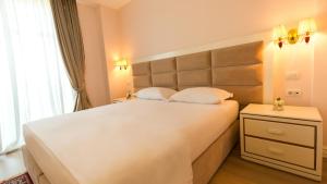 Postel nebo postele na pokoji v ubytování Royal Hill Hotel