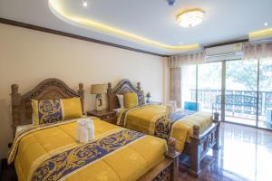 Giường trong phòng chung tại Thanyawintra Boutique and Spa