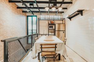a room with a table and chairs on a balcony at MEEMAW'S House Hostel in Bangkok