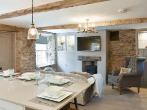 a living room with a table and a couch at no 8 main street in Sedbergh