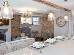 a living room with a table and a couch at no 8 main street in Sedbergh