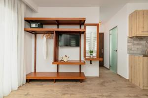a living room with a bench and a window at DIKAP Luxury Aparts in Limenaria
