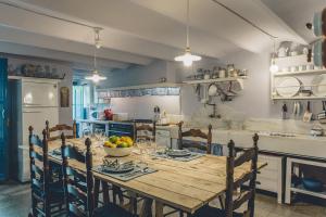 a kitchen with a wooden table with a bowl of fruit on it at Casa Baulenas in Caldes d'Estrac