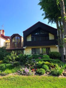 a house with a garden in front of it at Butai labai geroje vietoje prie juros in Palanga