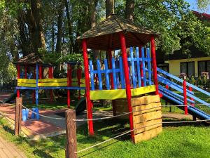 a playground with colorful play equipment in a park at Butai labai geroje vietoje prie juros in Palanga