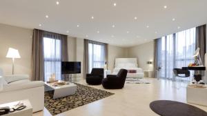 a large room with a bed and a living room at Hotel Gran Bilbao in Bilbao