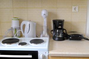 a kitchen counter with a stove and a blender at Marathona's Apartment in Aegina Town +19 photos